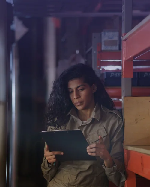 Checking stock between the shelves of a storeroom