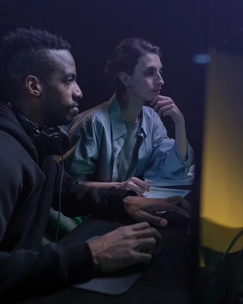 A mentor and a learner working side by side at a screen